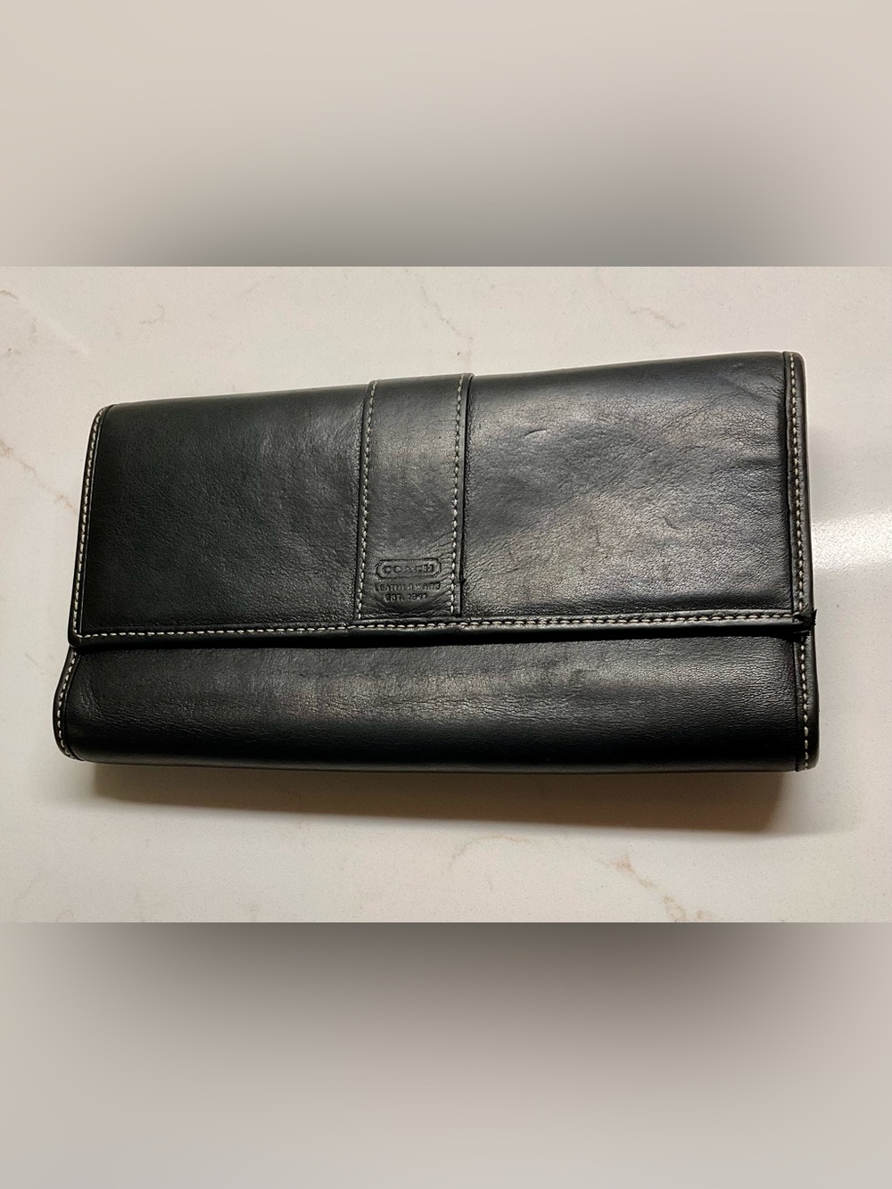 Coach Women’s Lovely rich black leather with stitching accent vintage wallet.